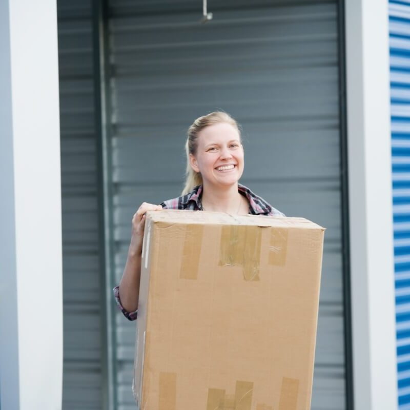 Smiling Woman Outside Storage Unit